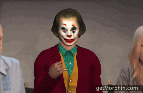 Digital art gif. A 3D rendering of Joaquin Phoenix's Joker tossing gold confetti into the air, superimposed between two live action people.