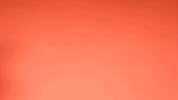 Video gif. Against a light orange background, three people cha-cha across the screen, the words "Teamwork makes the dream work" appearing as they walk.