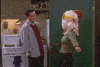 Friends gif. Matthew Perry as Chandler laughs while Courteney Cox as Monica dances in the kitchen, wearing a raw turkey over her head with a hat and sunglasses.