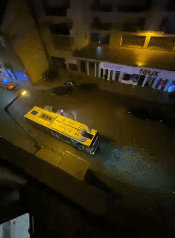 Cars Drive Along Flooded Street in Lisbon