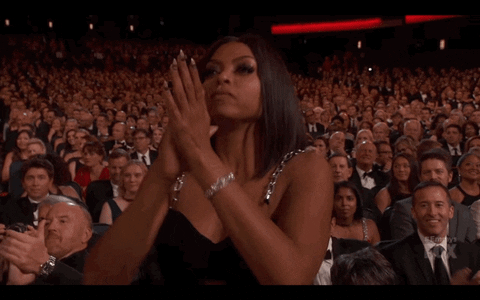 Celebrity gif. While the rest of the audience remains seated, Taraji P Henson stands and proudly claps for someone on stage.