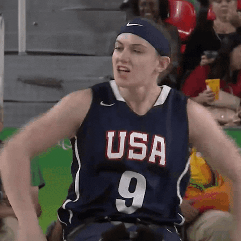 Sports gif. A female United States Paralympics wheelchair basketball player pumps both fists and shouts "let's gooooo," with a long drawn-out go.