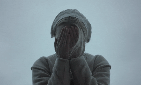 Movie gif. Playing peek-a-boo, Anya Taylor-Joy as Thomasin in The Witch covers her eyes with her hands then throws them to the side and yells, “BOO!”