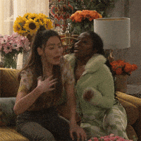 TV gif. Miranda Cosgrove as Carly Shay from iCarly is reeling from some serious drama, and fans herself as she takes a seat on a couch. A supportive friend sitting next to her fans her as well. Text, "Oh my god!"