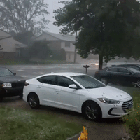 Car Drives Through Flooded Michigan Street