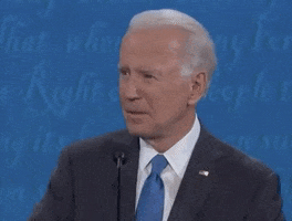 Video gif. Joe Biden stands in front of a mic during a presidential debate, and he has just heard something so ridiculous that he snaps his head to look at the audience with the most confused expression on his face.