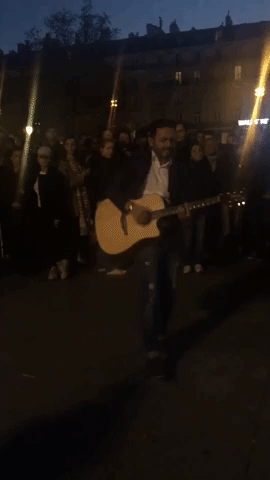 Guitarist Leads Crowd in Singing Leonard Cohen's 'Hallelujah' in Paris