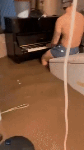 Queensland Man Plays Piano in Flooded Garage
