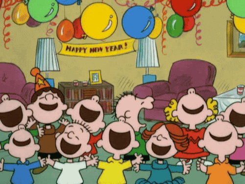 Peanuts gif. Cast of characters shout for joy in a living room while colorful balloons fall down from the ceiling. Banner in the background reads, "Happy New Year!"