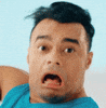 Video gif. A man is extremely shocked and his eyes and mouth are wide open. He quivers and vibrates very strongly from fear.