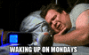 TV gif. Eric Stonestreet as Cameron from Modern Family lies in bed crying, while devices glow at him from a bedside table in the foreground. Text, "Waking up on Mondays."
