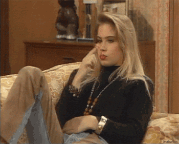 TV gif. Christina Applegate as Kelly in Married with Children. She lounges on a couch playing with gum that's in her mouth. She rolls it round and round on her fingers and her eyes follow the movement.