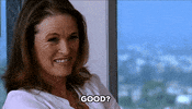 Celebrity gif. Lisa Love nods and smiles quizzically. Text, "Good?"