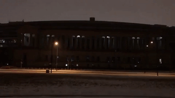 Soldier Field Columns Illuminate During COVID Memorial in Chicago