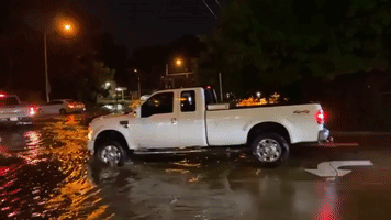 Drivers Navigate Flooded Streets in Lafayette as State of Emergency Declared