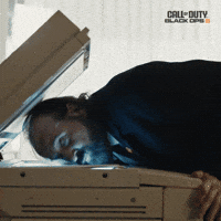 Sponsored gif. Actor Peter Stormare places his face on an office scanner to make a copy of his face.