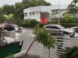 Cars Drive Through Floodwaters in Miami