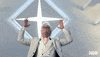 TV gif. Walton Goggins as Baby Billy Freeman from The Righteous Gemstones seems to be having a spiritual moment. Wearing white clothes in a white room, he raises his hands emphatically beneath a four-pointed star decoration.