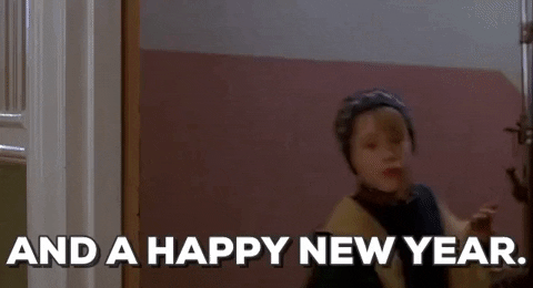 Movie gif. Macaulay Culkin as Kevin in Home Alone Two leans through a doorway and smiles with a smirk. Text, "And a Happy New Year."