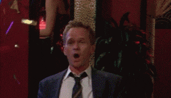 TV gif. Neil Patrick Harris as Barney in How I Met Your Mother. He sits up straight at the bar and confetti goes off and he claps his hands loudly while whooping.