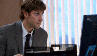 The Office gif. John Krasinski as Jim sits at a desk in a different office looking at his screen nervously, finally looking at us slowly, and very slightly shakes his head, trying not to be noticed. 