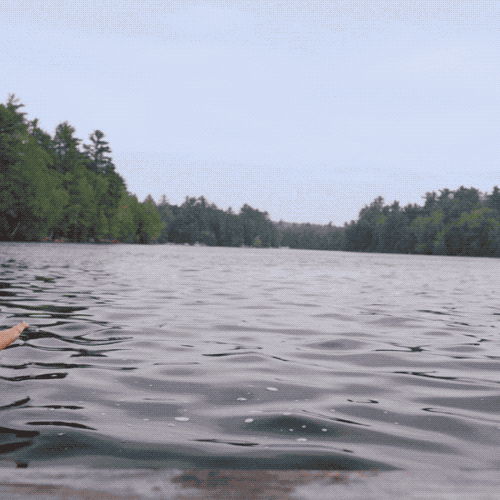 Ad gif. Man and woman float past us in inner tubes holding cans of Twisted Tea.