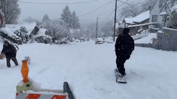 Snowboarders Shred on Olympia Streets as Winter Storms Continue