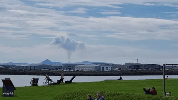 Reykjavik Residents Enjoy a Sunny Beach Day as Volcano Erupts in the Distance