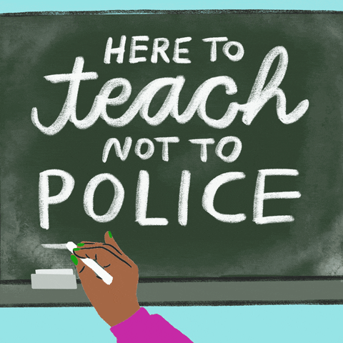 Digital art gif. Cartoon hand writes white script on a cartoon chalkboard that says, "Here to teach not to police."