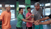 Reality TV gif. Members of The Dude Perfect Show place a hand on top of one another's as a sign of team work. They chant together then toss their hands up in unison. 