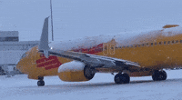 Airport Staff Deice Plane as Lake-Effect Snow Hits Rochester