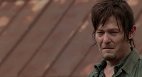 TV gif. Norman Reedus as Daryl Dixon in The Walking Dead beginning to break down crying.