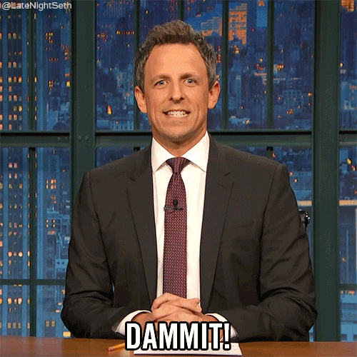 Late Night gif. Seth Meyers rests interlocked hands on his desk as he nods and clenches his teeth while saying, "Dammit!"