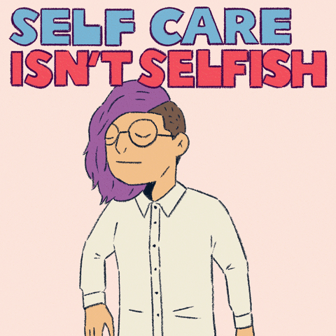 Digital art gif. Animation of a cartoon person with purple hair and an undercut hugs their arms tightly around themselves, their eyes closed peacefully. Blue and red text reads, "Self care isn't selfish," everything against a light pink background.