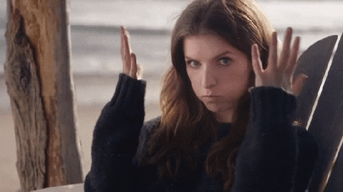 Celebrity gif. Anna Kendrick sits in a wooden chair on the beach. She holds her hands by her head in a "mind blown" gesture, then rolls her eyes at us and seems to say "I know."