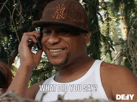 Reality TV gif. Man on Dog The Bounty Hunter holds a phone up to his ear and with a smile says, “What did you say?”