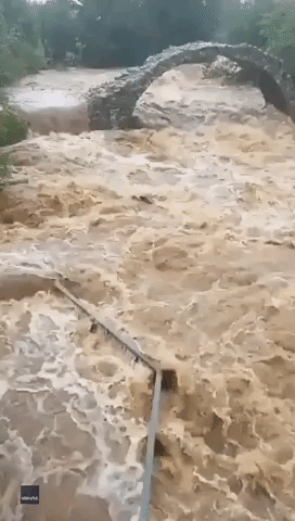 Flooded River Rages Under Historic Bridge in Scottish Highlands
