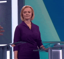 Political gif. Liz Truss rolls her eyes, raises her eyebrows, and subtly throws up her hands, as if she's completely over it.