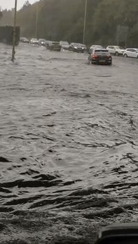 Cars Drive Through Floodwaters as Heavy Rain Drenches Northeast England