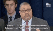 Video gif. Manhattan District Attorney Alvin Bragg speaks at a press conference after former President Donald Trump is convicted in his hush money trial. Flanked by his team, Bragg says "Donald Trump has been convicted of 34 counts of falsifying business records." as cameras flash on him. 