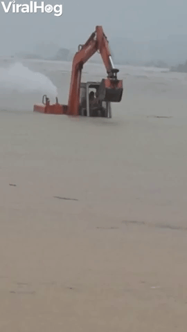 Excavator Returning to Shore Wades in Floodwaters