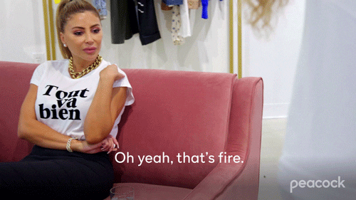 Reality TV gif. Larsa Pippen on The Real Housewives of Miami. She's sitting on a couch in a store and is judging someone's outfit. She says, "Oh yeah, that's fire."