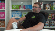 Ad gif. Picking up a "world's best boss" mug, man exhales and leans back in his office chair and says, "boy, that escalated quickly," which appears as text.