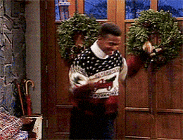 TV gif. Alfonso Ribeiro as Carlton in Fresh Prince does his signature dance in front of a front door. He's wearing an ugly Christmas sweater--typical. 