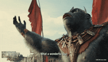 Trailer gif. A scene from the movie "Kingdom of the Planet of the Apes" shows Proximus Caesar wearing a three-horned metal crown and standing in front of the dilapidated remains of a shipwreck. Proximus stretches his arms to the hazy sky and yells "What a wonderful day!" before smiling. 