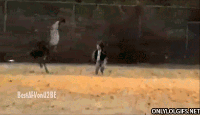 Wildlife gif. An ostrich is chasing a toddler through the field and the toddler looks rightfully freaked out as he runs away.