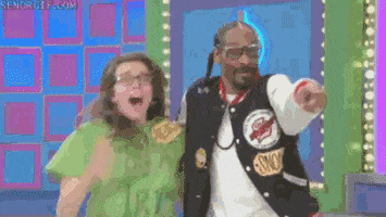 Reality TV gif. Snoop Dogg excitedly points to a prize as he runs with an ecstatic game show contestant in The Price is Right. She screams happily and flails her arms in disbelief.