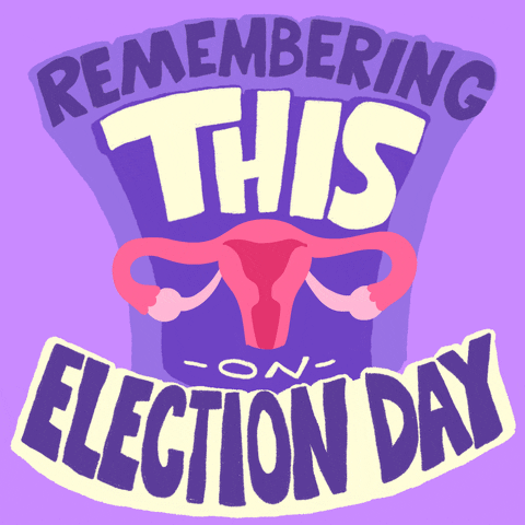 Digital art gif. In large, purple all-caps letters, text reads, "Remembering this on Election Day." Amid the text, a set of pink animated scales transform into a bright pink uterus., all against a lilac background.