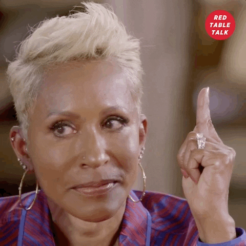 Celebrity gif. Adrienne Banfield-Jones on Red Table Talk points her index finger in the air as she darts her eyes and licks her lips, looking nervous but certain.
