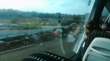 Upturned Cars and Debris Line Road After Mallorca Flooding